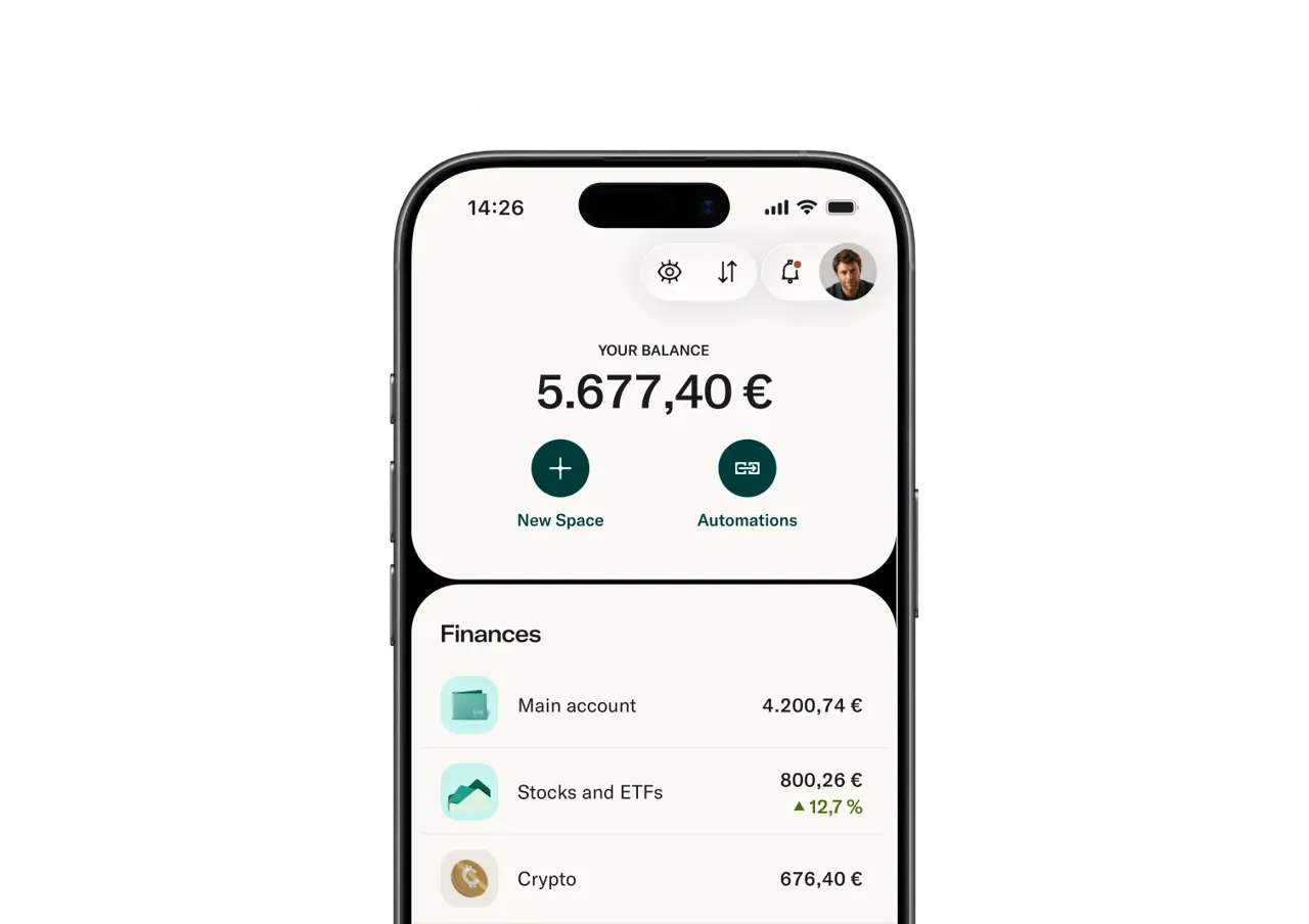 A smartphone screen displays a banking app interface showing a total balance of 5.677,40 € alongside financial accounts for main savings, stocks and ETFs, and cryptocurrencies.